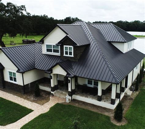 white house black metal roof|house with black metal roof.